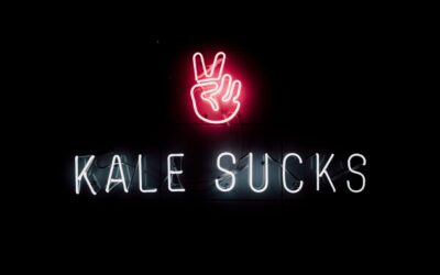 neon sign that reads Kale Sucks